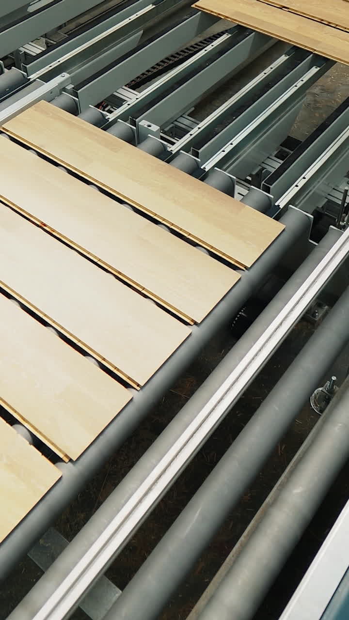 Floorboard production in the industrial factory. Manufacturing of a parquet board. Modern technologies. Vertical video