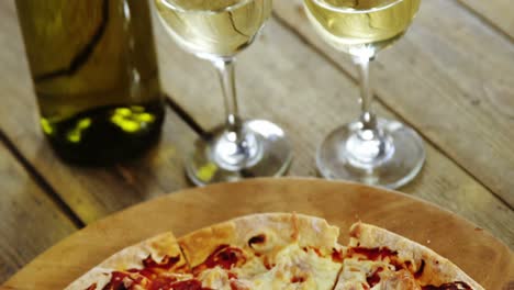 Delicious-pizza-with-a-glasses-of-wine-and-wine-bottle