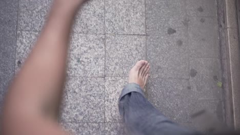 person walking on a tiled pavement