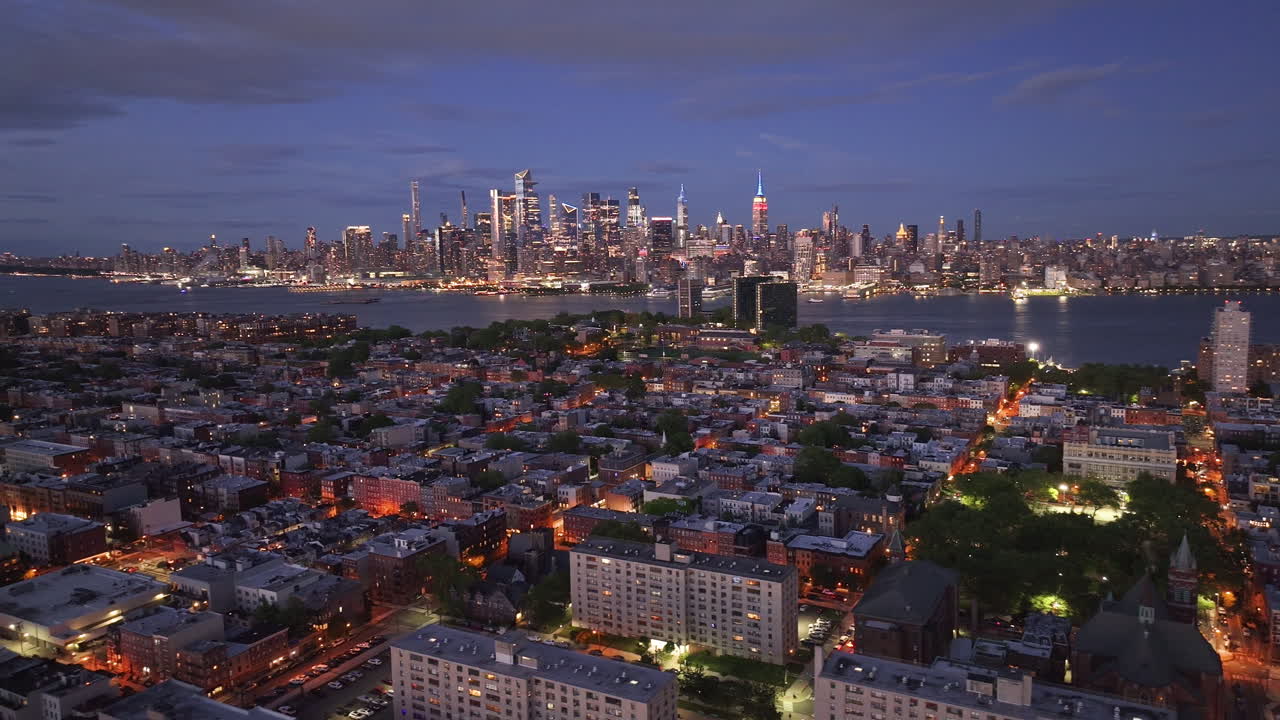 Aerial view of Hoboken, New Jersey at night. Shot with Midtown Manhattan in the background.