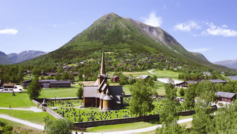 Medieval-Wooden-Lom-Stave-Church-Surrounded-With-Tombstone-In-Lom,-Innlandet-County,-Norway