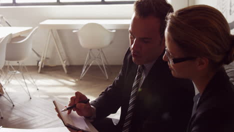 Serious-business-people-working-together-while-looking-clipboard