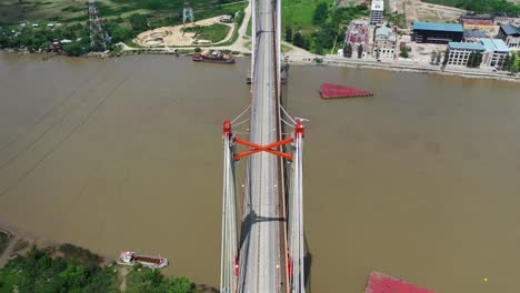 Aerial-footage-from-the-distance-of-Zarate-bridge-in-Argentina-with-many-cars-driving-through-it