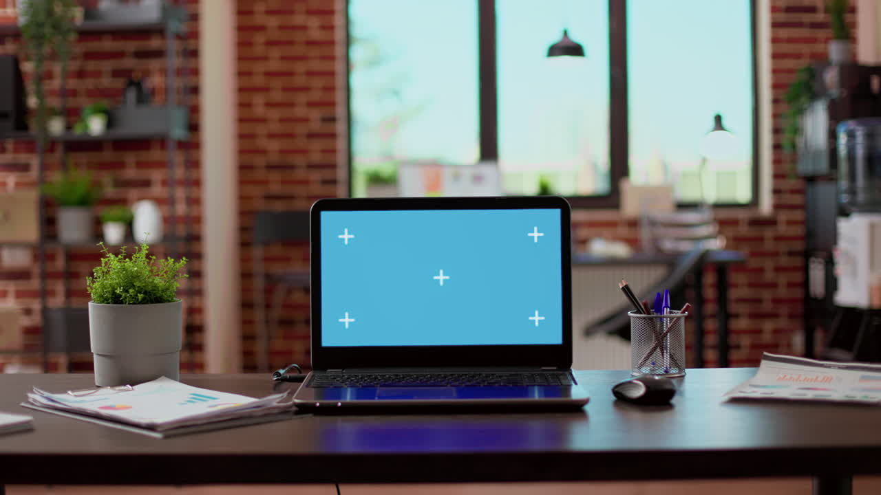 No people in empty office with greenscreen display on laptop