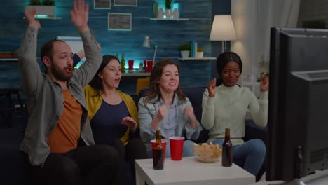 multiracial friends celebrating football goal during game competition