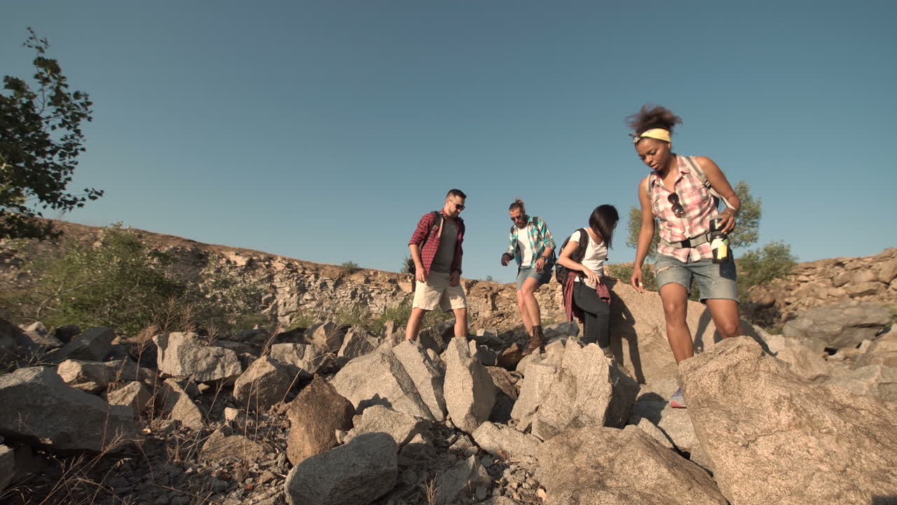 Group of friends hiking through rocky terrain