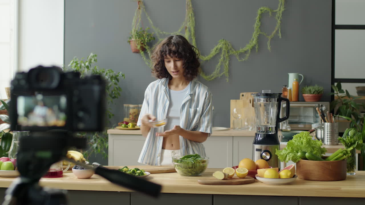 Female Blogger Filming Healthy Food Recipe in Kitchen