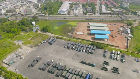 aerial top view of truck cars parking stock lot row in industry factory, dealer inventory import and export business commercial, automobile and automotive industry distribution logistic transport