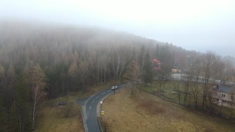 Aerial-View-Of-Transportation-Asphalt-Road-Across-Mountain-With-Fog