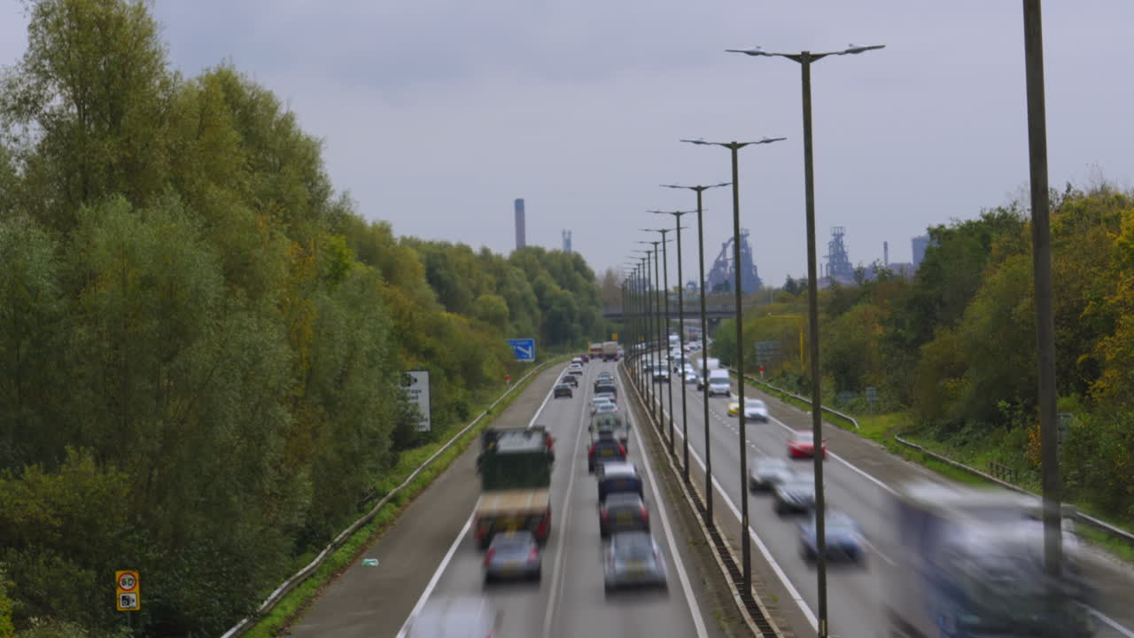 Busy Highway with Factory in the Background