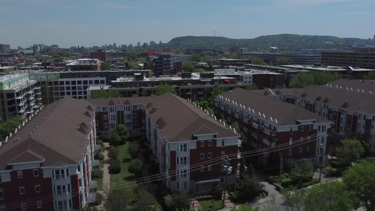 Apartment buildings with aerial view on Mont Royal and Montreal downtown skyline