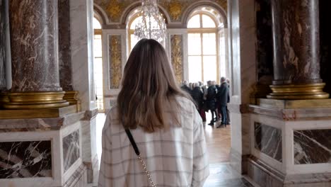 woman-walking-in-The-Palace-of-Versailles,-France