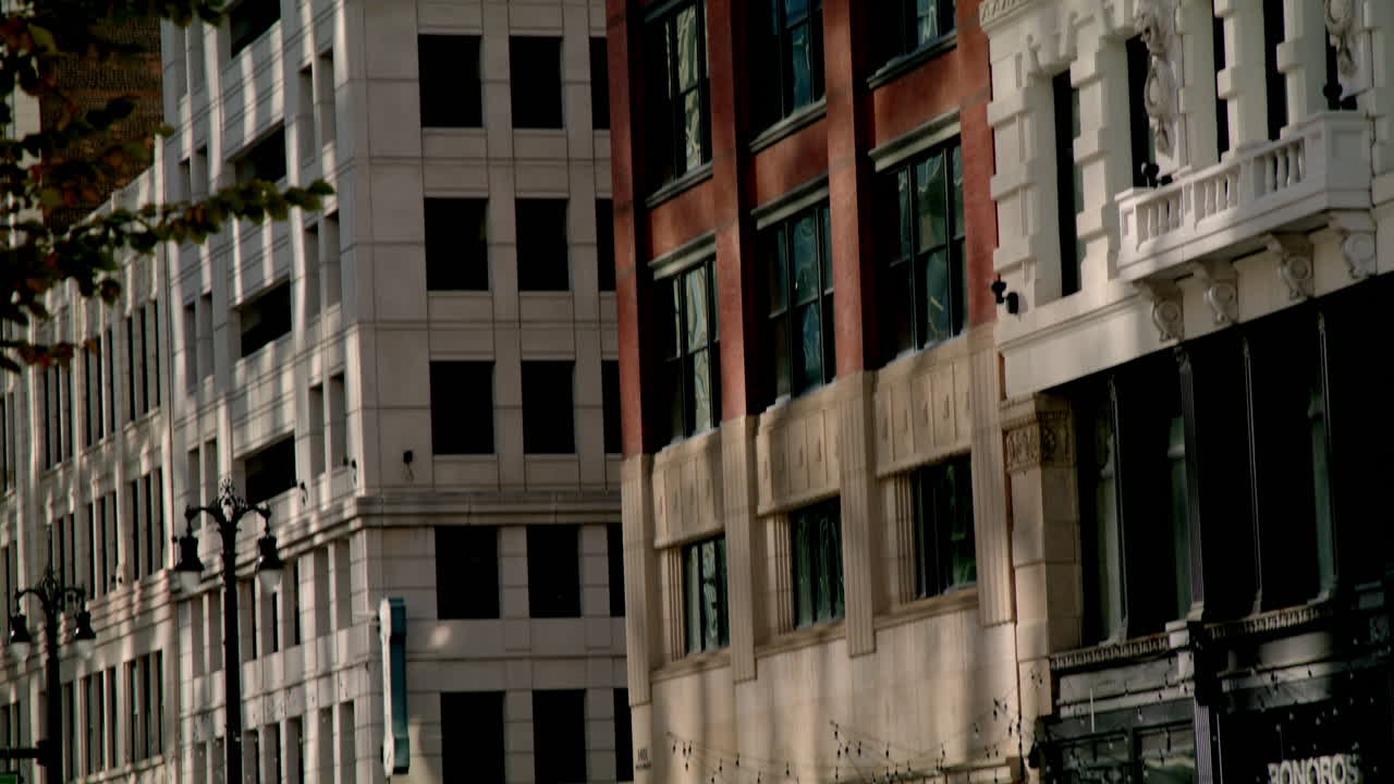 Close up of buildings in downtown Detroit, Michigan with video tilting down.