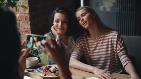 Friends Taking Photos at a Cafe