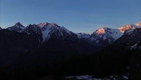 Aerial-shot-of-Mountain-Range-with-Snow-Covered-Summits