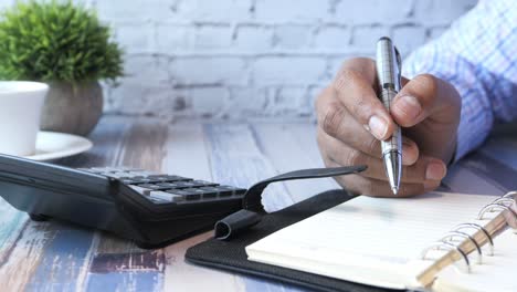 person taking notes at a desk