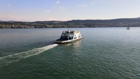 aerial drone panning shot showing two car ferries sailing towards each other on lake zürich in switzerland