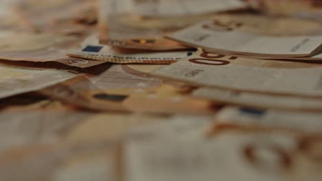 Beautiful-macro-dolly-of-cash-money,-a-lot-of-50-euro-bills-are-scattered-over-the-surface