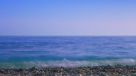 Timelapse-at-a-rocky-beach-with-clear-sky-during-the-day