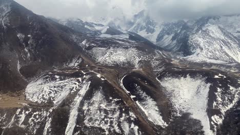 flying through the rugged terrain of the himalaya mountains in nepal with snow covered landscape