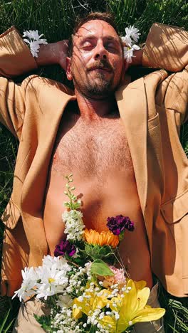 man relaxing in a field with flowers