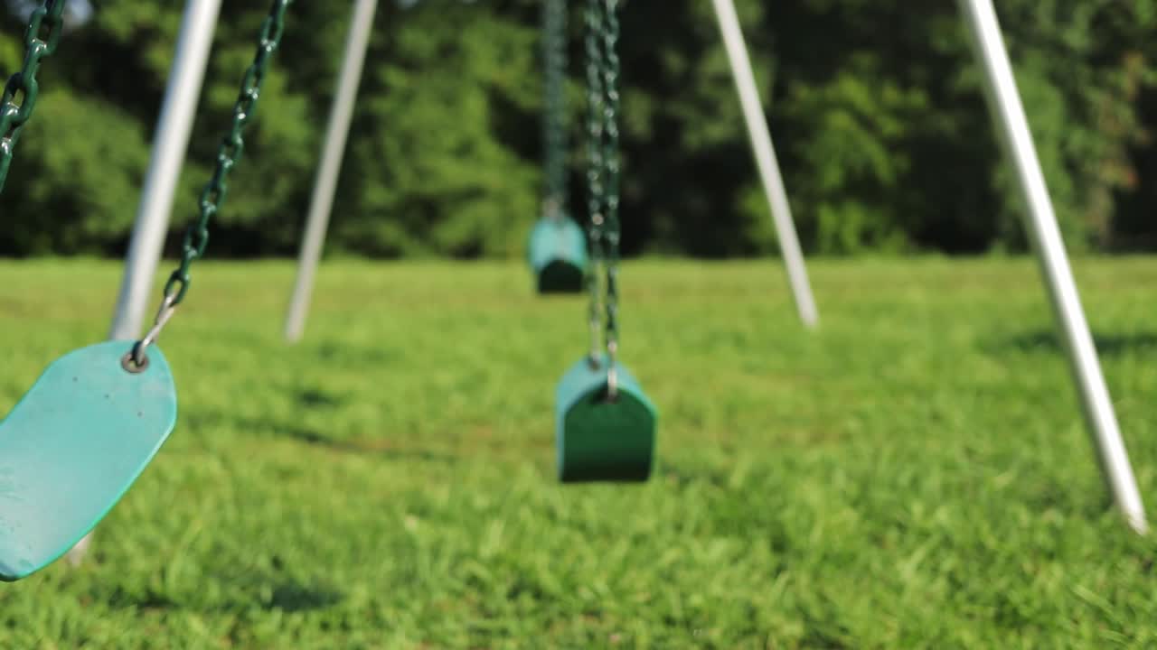 Empty Playground Swing Swinging Back And Forth With No One In It
