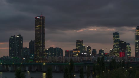 63 square skyscraper at yeouido island with hangang railway bridge in foreground at night in seoul, south korea