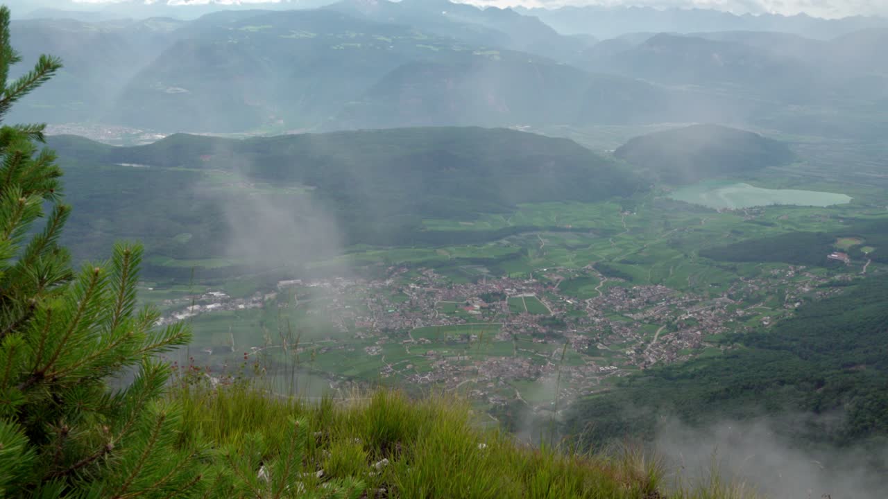 Clouds move through and gradually block the view of Kaltern - Caldaro, South Tyrol, Italy and its surroundings