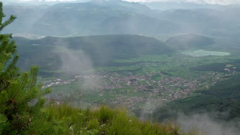 clouds move through and gradually block the view of kaltern - caldaro, south tyrol, italy and its surroundings