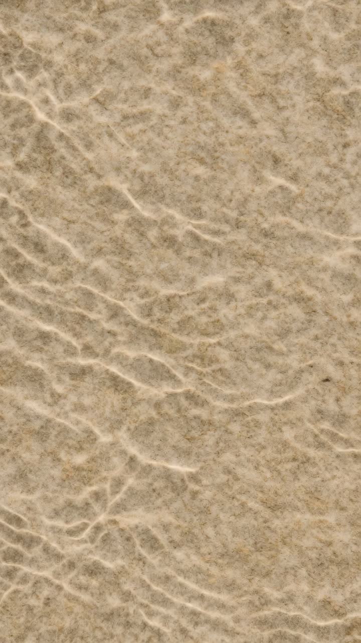 Close-up, top-down view of textured, wrinkled paper surface
