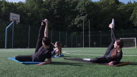 a group of three women performs yoga poses outdoors under sunny skies highlighting athleticism a group of three women performs yoga poses outdoors under sunny skies highlighting athleticism flexibility and balance in a natural environment