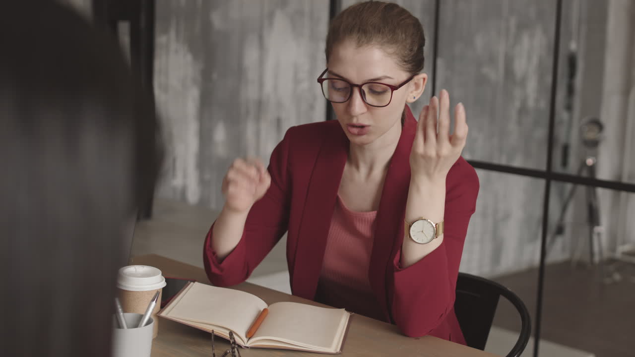 Caucasian Businesswoman Talking to Unrecognizable Colleague