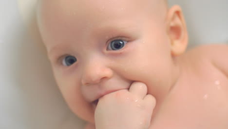 lovely blue-eyed baby girl bathing