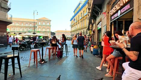 people enjoying pizza at a street-side eatery