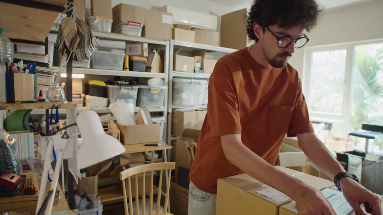Man Putting Address Labels on Parcels in Delivery Service Office