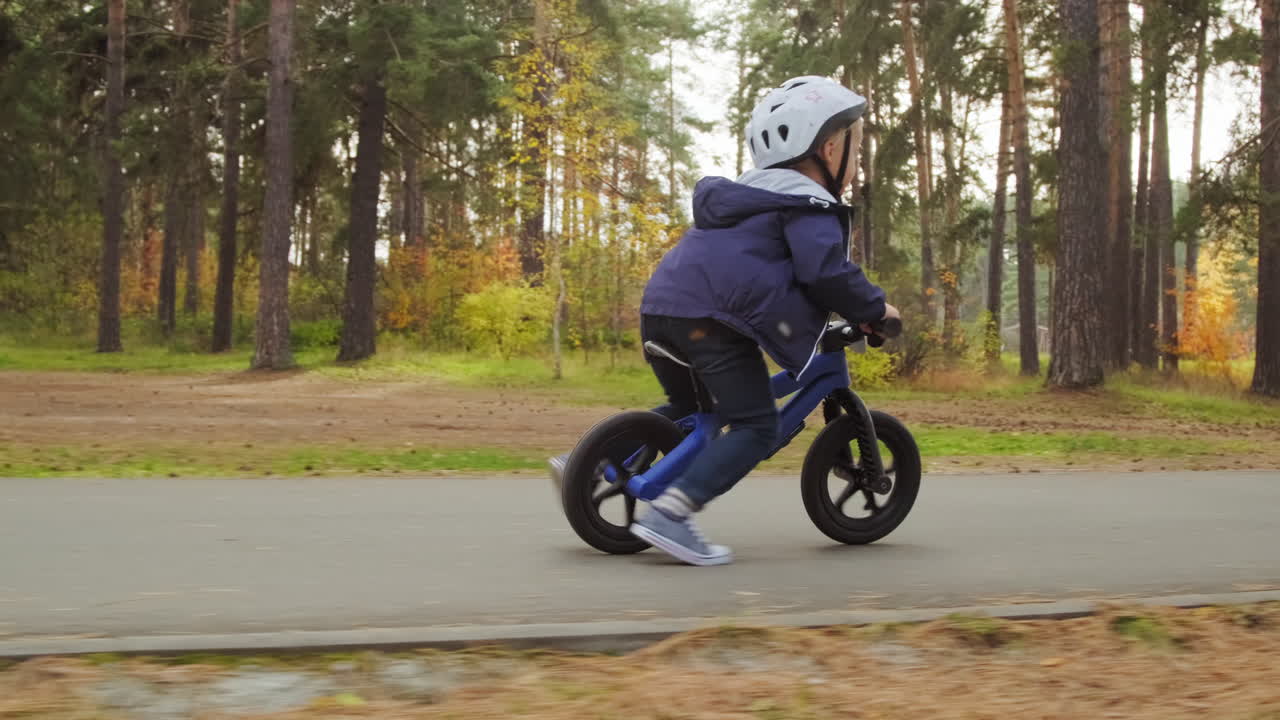 Cute Boy in Helmet Riding Balance Bike