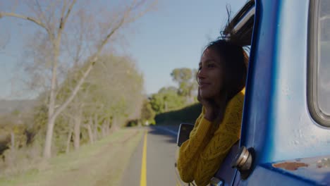 young woman on a road trip in pick-up truck