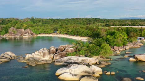 aerial zoom out of rocky tropical coastline at