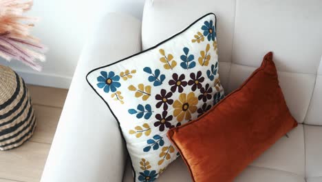 close up of two throw pillows on a white couch