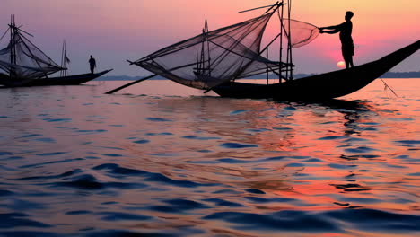 silhouette of fishermen at sunset