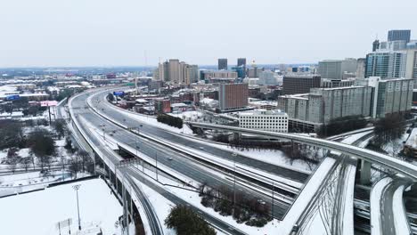 static aerial shot of snow covered interstate 75-85 south in downtown atlanta georgia on january 10th 2025.