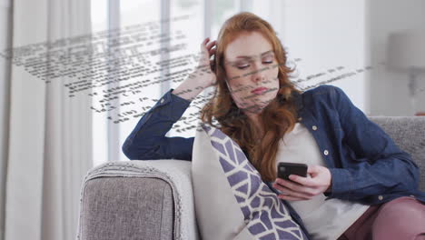 woman reclining on sofa scrolling smartphone, with floating code lines highlighting technology