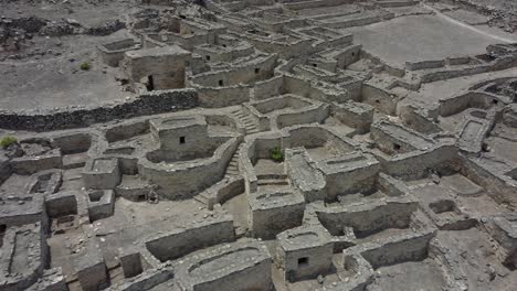 drone video of a 500 year old abandoned stone town on a mountain side