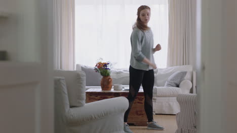 beautiful woman dancing at home practicing ballet dance moves having fun rehearsing in living room