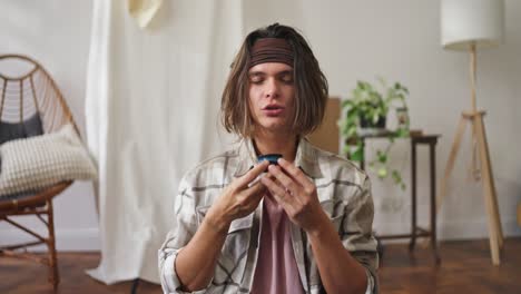 man enjoying a drink at home