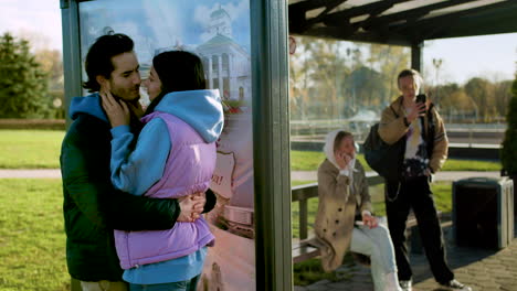 Couple-kissing-at-bus-stop