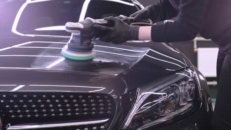 professional car detailing using machinery and polishers for paint restoration.