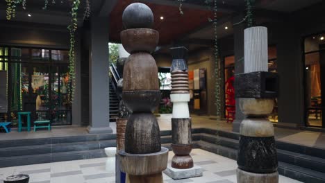 outdoor art installation featuring stacked wooden sculptures