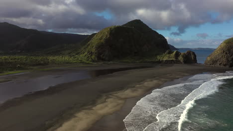 scenic panorama of whatipu beach with rocky formations huia reserve, new zealand