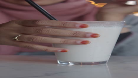 woman holding a milkshake